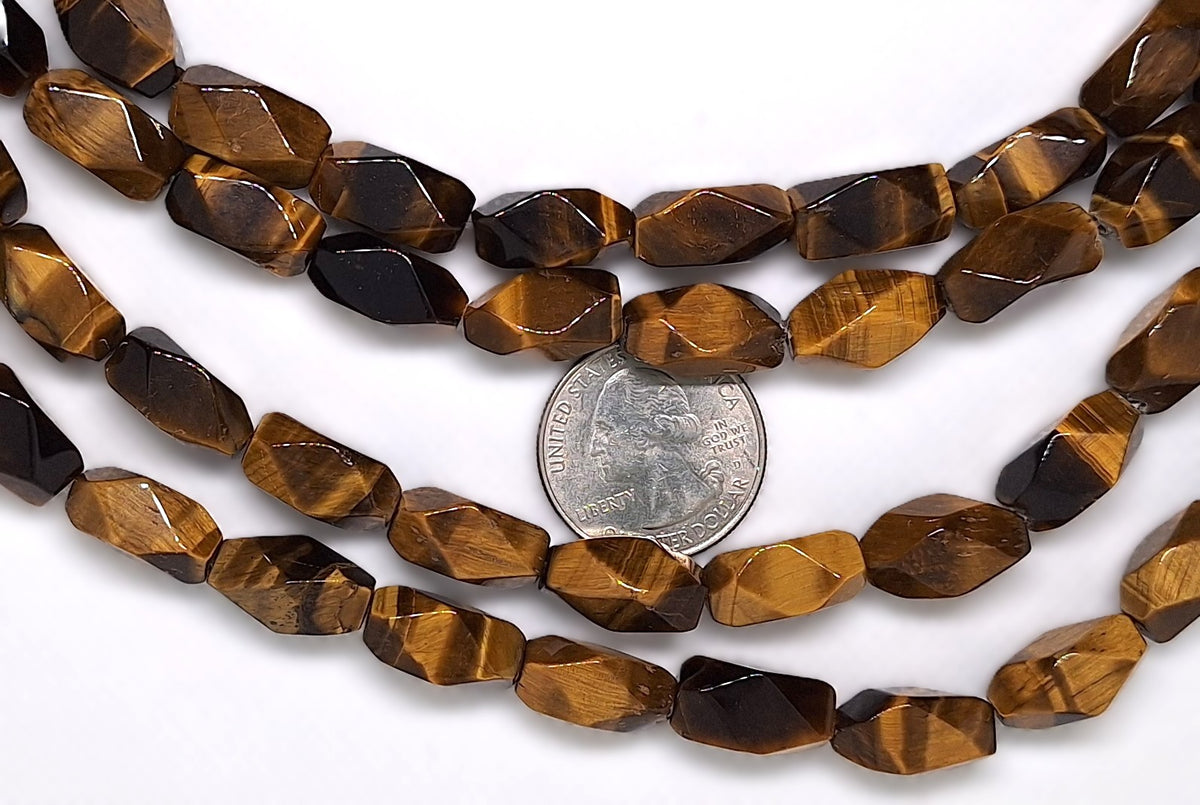 String of tiger eye beads with a quarter for size comparison on a white background