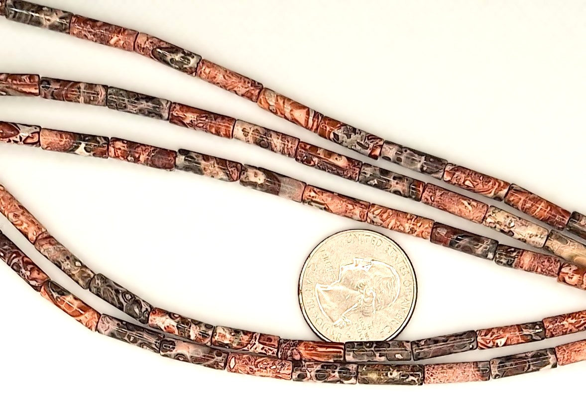 Three strands of brown and black beaded cord with a quarter for scale on a white background